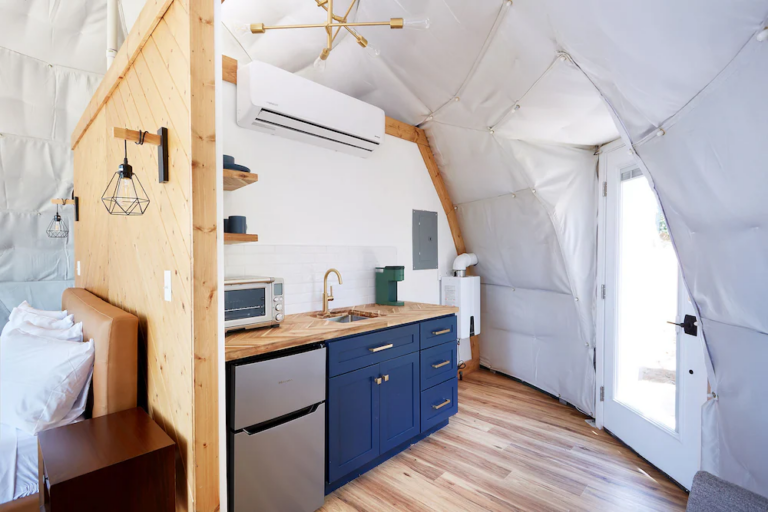 Aerial view of yurt cluster in a pristine wilderness setting