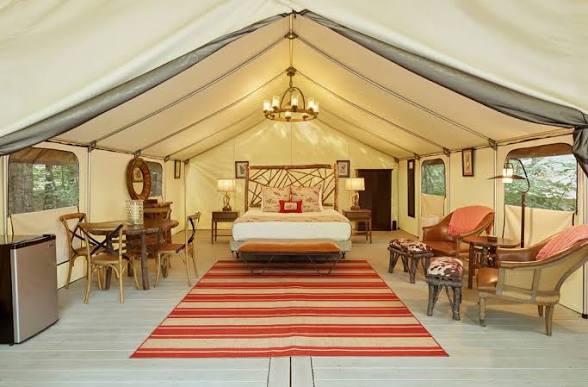 Yurt bathroom with stone soaking tub and forest views